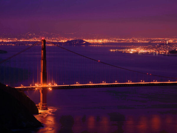 Golden Gate bridge and San Francisco skyline at night.